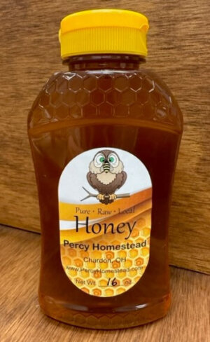 Picture of 1 lb honey comb plastic bottle of honey logo of owl with bee on nose and eyes crossed. By Percy Homestead