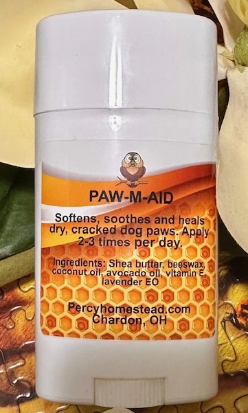 Deodorant style container with Label that reads Paw-M-Aid. Salve for softening dog paws. Made with Shea Butter, Beeswax, coconut oil, avocado oil vitamin e and lavender essential oil